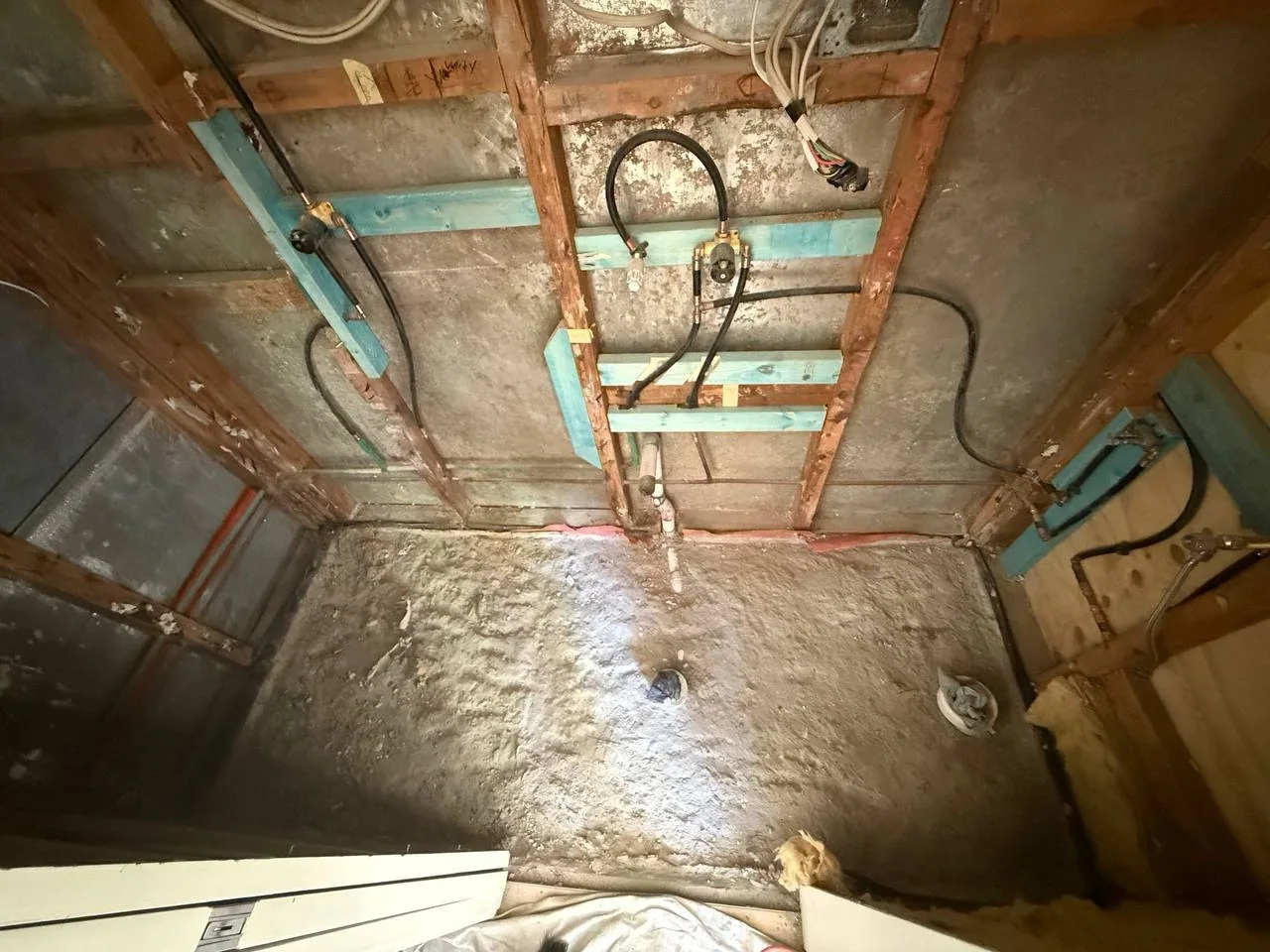 Exposed timber framing and bathroom plumbing rough-in