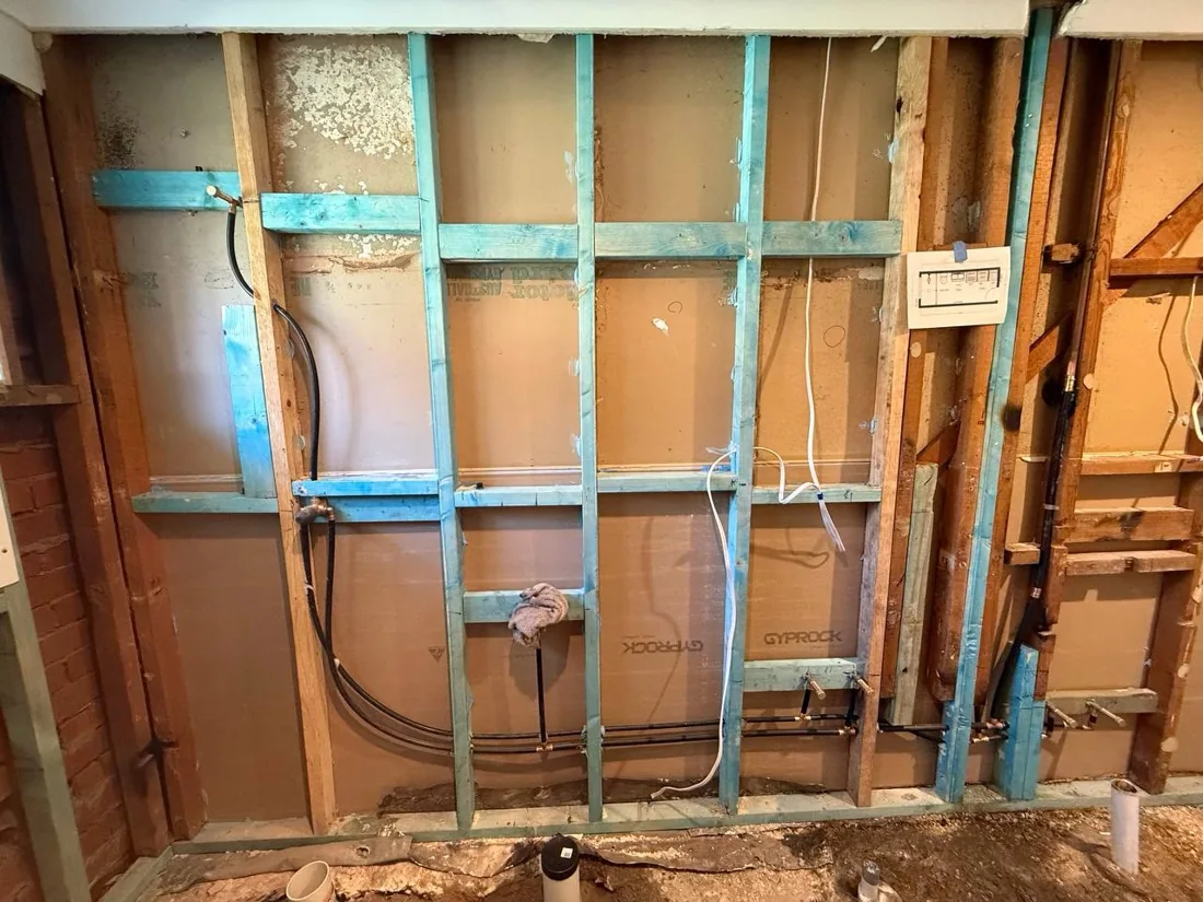 New plumbing lines installed within the exposed wall framing