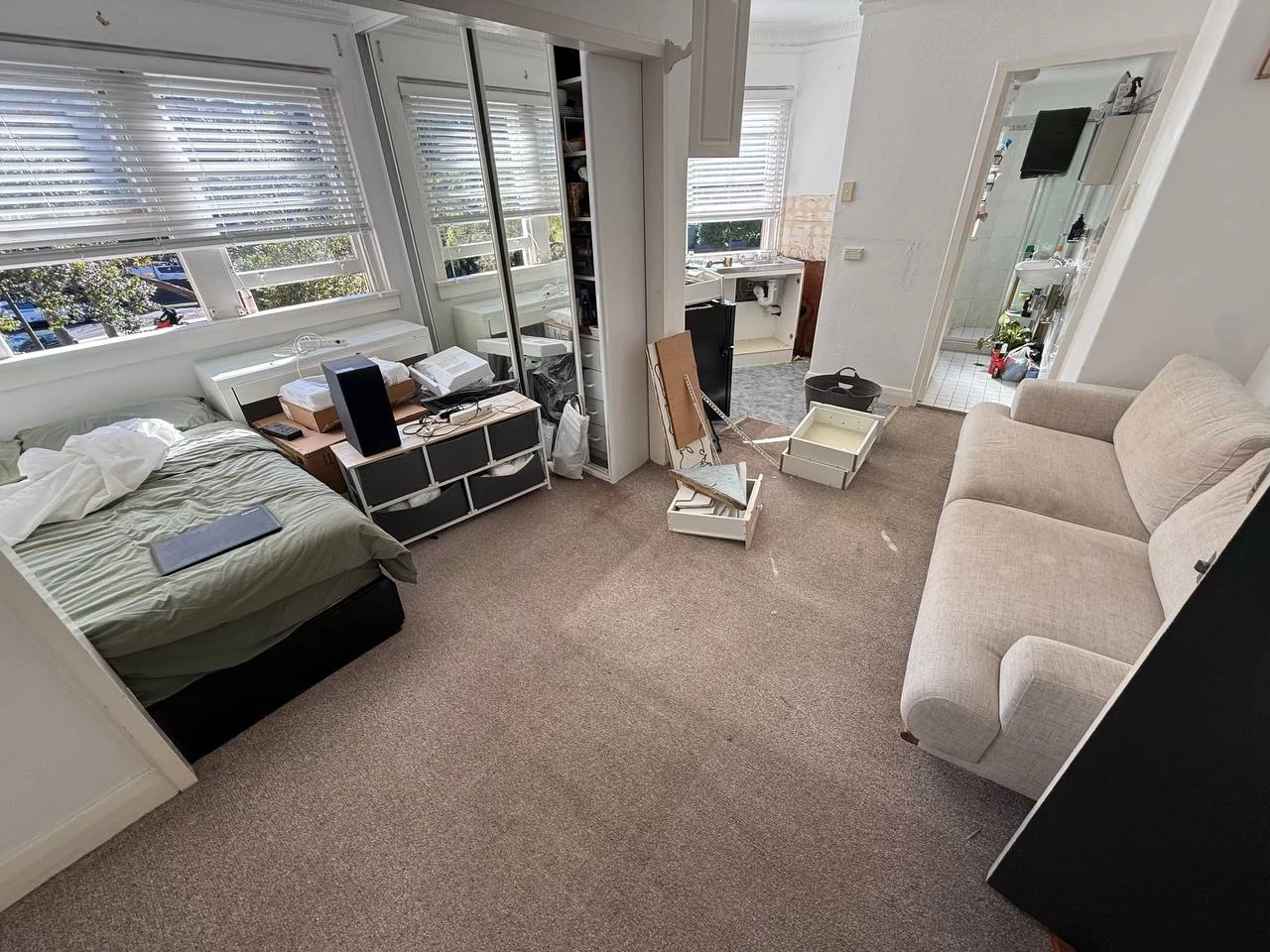 Potts Point studio before renovation with carpeted floor and original furnishings